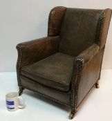 A circa 1900 buttoned leather upholstered wing back scroll arm child's chair on square tapered legs