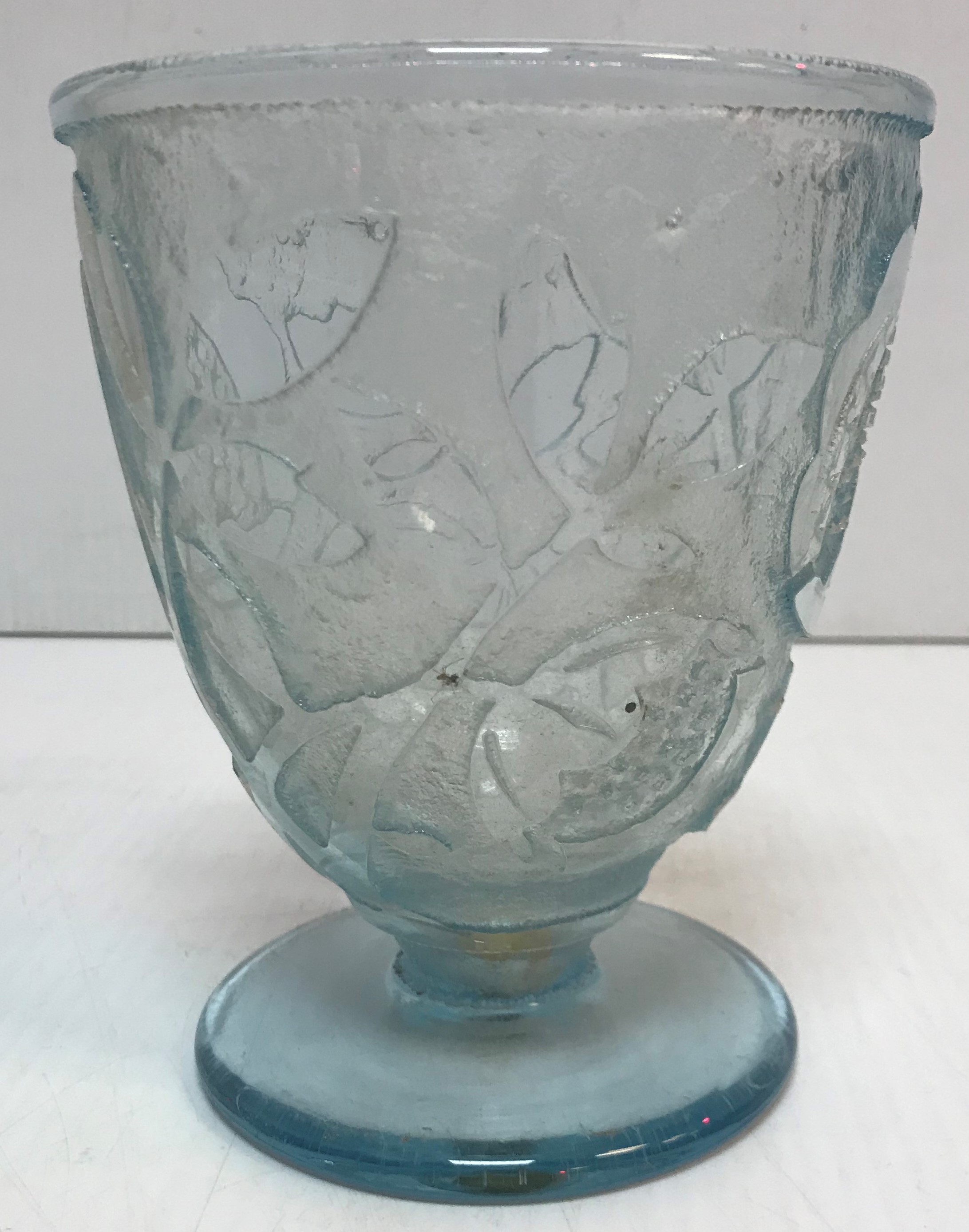 A Daume Nancy cut glass vase depicting stylised flowers, raised on a circular pedestal foot,