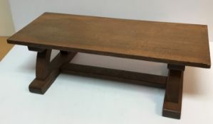 A small oak bench in the Arts & Crafts manner,