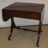 An early 19th Century mahogany and rosewood strung drop-leaf sofa table,