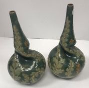 A pair of Doulton Lambeth foliate decorated vases with narrow rims,