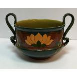 A Minton's style twin handled jardiniere with Art Nouveau style decoration on a green and red