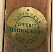 A croquet set, the box bearing label inscribed "Solid Teak Croquet Limited Edition Oxford England",