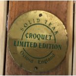 A croquet set, the box bearing label inscribed "Solid Teak Croquet Limited Edition Oxford England",