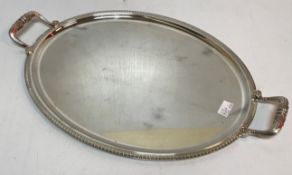 A Christofle of France twin handled plated tray of oval form with acanthus leaf decoration together