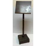 A mahogany adjustable music stand on a turned tapering pedestal to studded leather upholstered