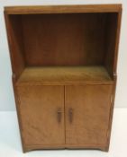 An oak cupboard in the Arts & Crafts manner of small proportions,