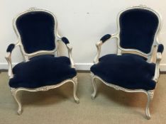 A pair of circa 1900 painted beech framed salon elbow chairs in the Louis XV taste with upholstered