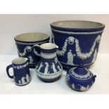 Five items of Wedgwood blue jasperware including large jardiniere with swag and classical figure