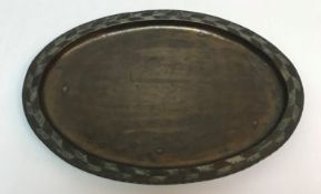 A Hugh Wallis oval tray with chevron design decoration to rim, bears maker's stamp,