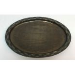 A Hugh Wallis oval tray with chevron design decoration to rim, bears maker's stamp,