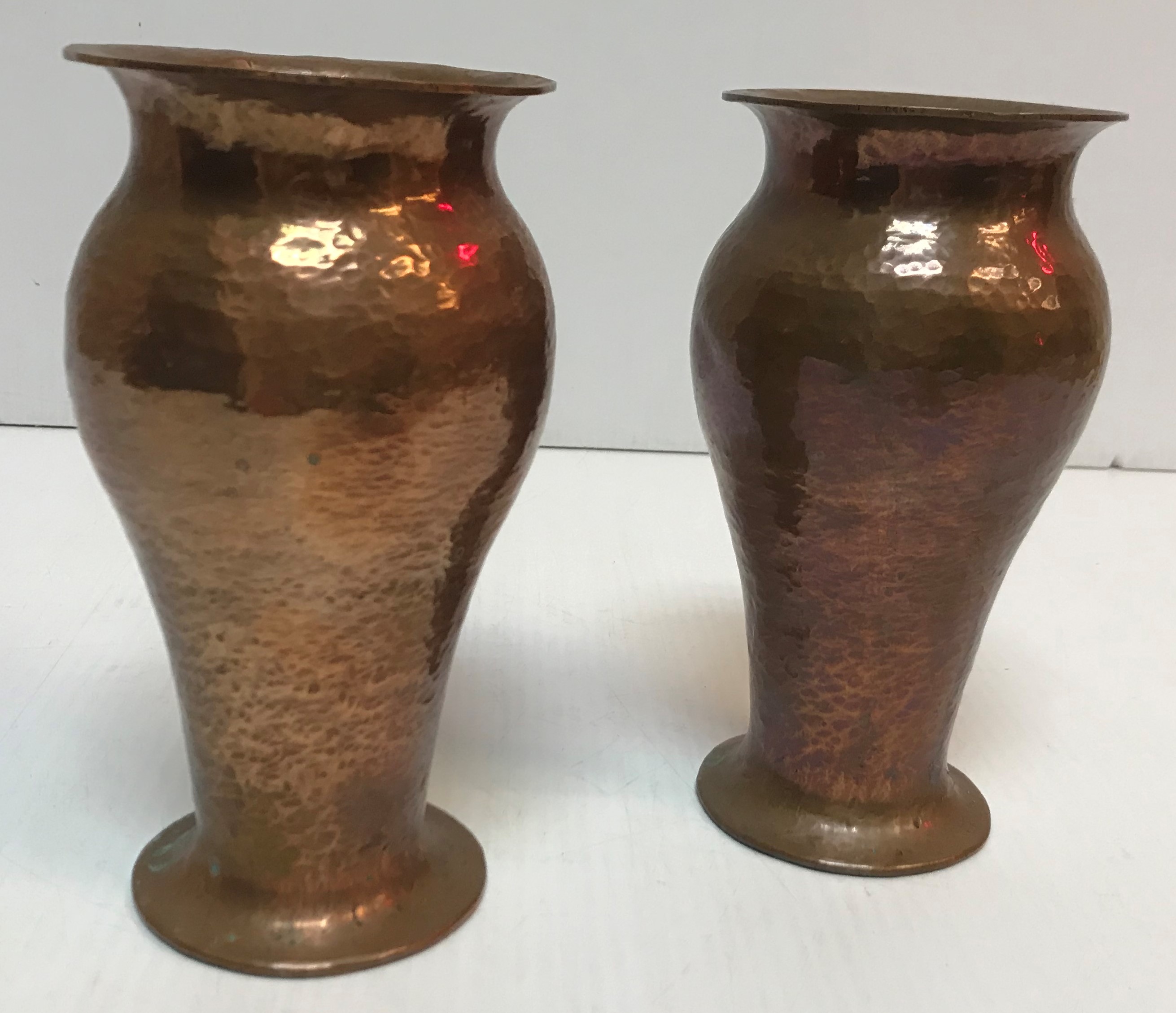 A pair of Richard Rathbone hammered copper baluster shaped vases with flared rims,
