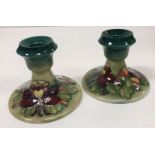 A pair of Moorcroft squat candlesticks,