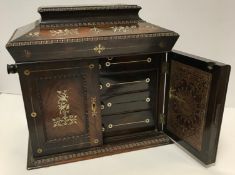 A Victorian rosewood and mother of pearl inlaid table top jewellery chest of sarcophagus form,