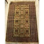 A Persian carpet, the central panel set with all-over floral design on a pale green ground,