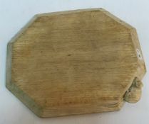 A "Mouseman" Robert Thompson of Kilburn oak cheese board of elongated octagonal form in light oak