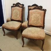 A set of four circa 1900 French carved walnut framed salon chairs with aubusson style tapestry