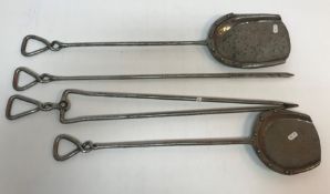 A set of four wrought iron fire tools, each with twisted handle, comprising poker,