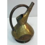 An early 20th Century brass water jug in the manner of Richard Perry,