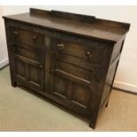 An early 20th Century oak sideboard with lunette style decoration,