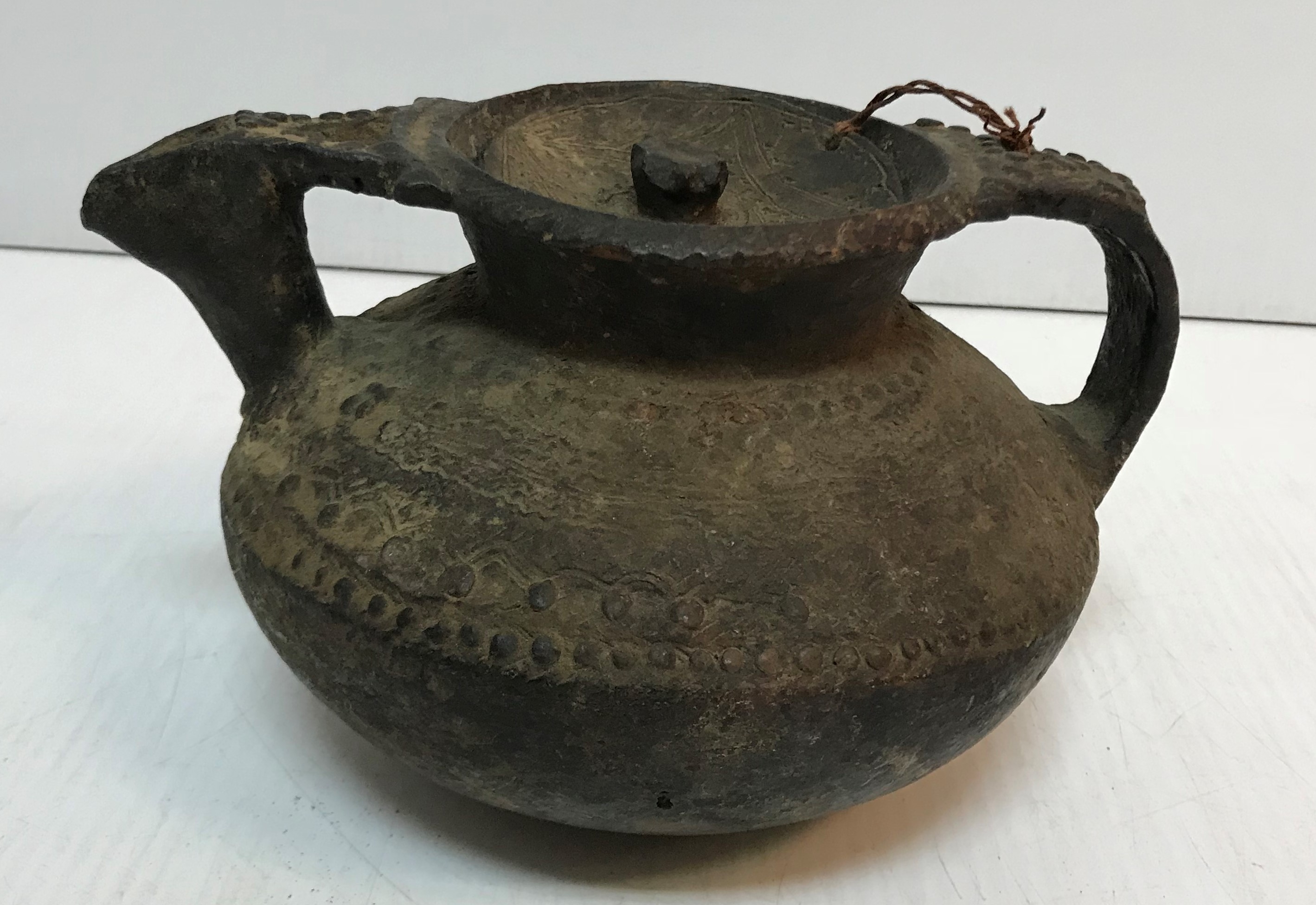An African terracotta teapot of bellied form with roundel and incised decoration, 13. - Image 2 of 2