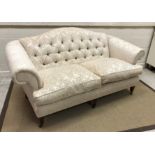 A Wesley Barrell button back scroll arm two seat sofa on square tapered legs to casters 187 cm wide