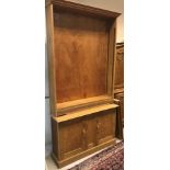 An early to mid 20th Century light oak bookcase cabinet,