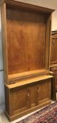 An early to mid 20th Century light oak bookcase cabinet,