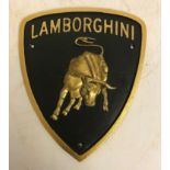 A modern painted cast iron sign inscribed "Lamborghini",