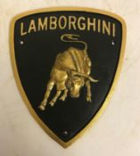 A modern painted cast iron sign inscribed "Lamborghini",