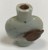 A blue and white snuff bottle decorated with figure seated amongst flowers, bearing wax seal, 5.