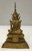 A 19th Century Sino-Tibetan gilt bronze figure of “Seated Buddha in lotus position” on a tapered