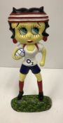 A modern painted cast iron figure of Betty Boo carrying a rugby ball,