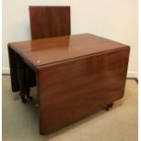 A Victorian mahogany rounded rectangular drop leaf extending dining table,