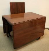 A Victorian mahogany rounded rectangular drop leaf extending dining table,