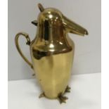 An Art Deco style brass jug as a penguin with scrollwork handle,