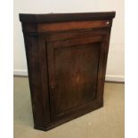 An 18th Century North Country oak and inlaid hanging corner cupboard,