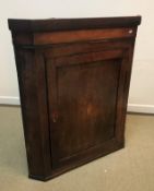 An 18th Century North Country oak and inlaid hanging corner cupboard,