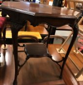 An Edwardian mahogany octagonal centre table with moulded edge over a shaped frieze and acanthus