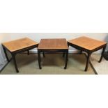 A set of three mid to late 20th Century American elm and ebonised occasional tables of square form