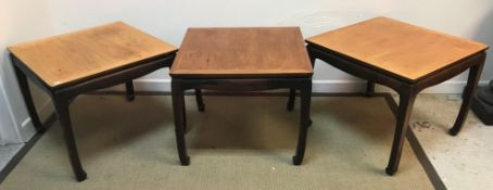 A set of three mid to late 20th Century American elm and ebonised occasional tables of square form