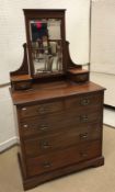 A circa 1900 mahogany two piece bedroom suite of single mirrored door wardrobe with drawer below