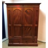 A modern mahogany double wardrobe with two drawer base 148 cm wide x 57 cm deep x 197.