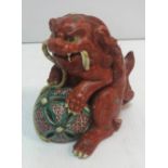 A 19th Century Chinese pottery figure of a Dog of Fo with ball,