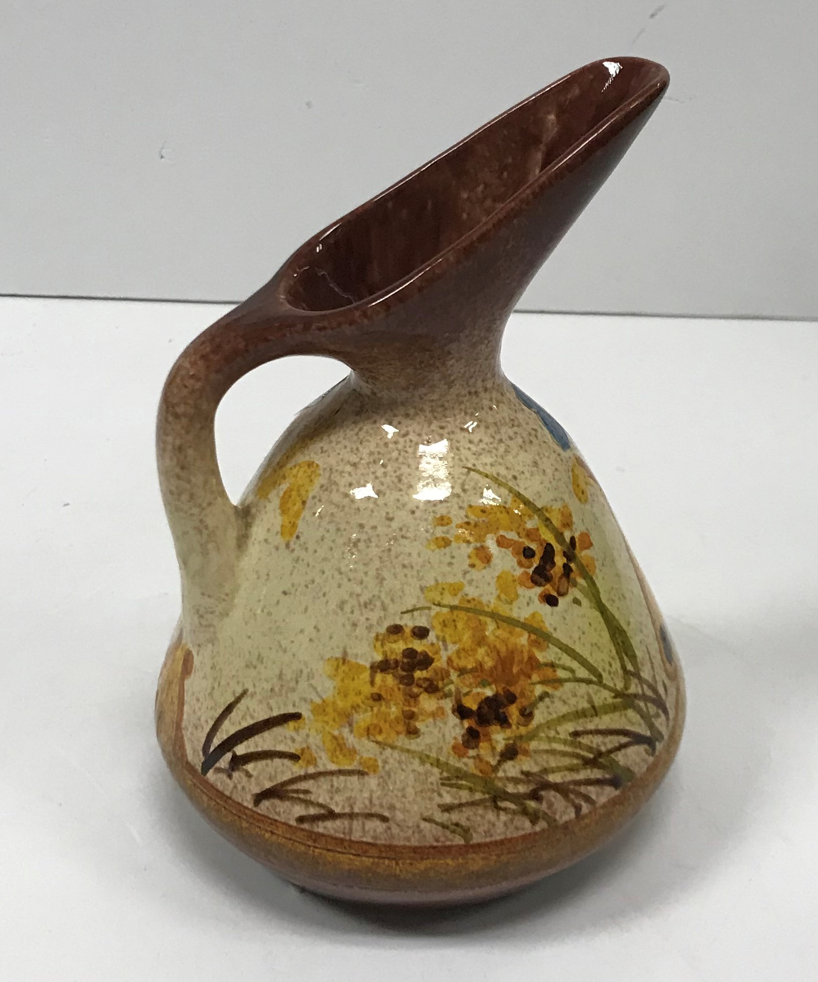 A William Ault Pottery ewer designed by Christopher Dresser with butterfly and foliate decoration