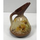 A William Ault Pottery ewer designed by Christopher Dresser with butterfly and foliate decoration