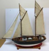 A model sailboat painted in red,