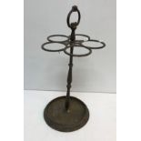 A 19th Century five section cast iron stick stand raised on circular base 61 cm high together with