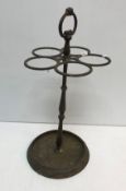 A 19th Century five section cast iron stick stand raised on circular base 61 cm high together with
