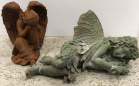 A modern cast iron figure of a fairy sleeping, approx 40 cm long,